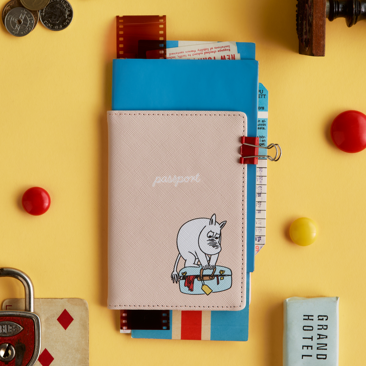 Moomin passport cover Holiday Rush - Holiday Rush passport holder on a yellow background with travel-themed items.