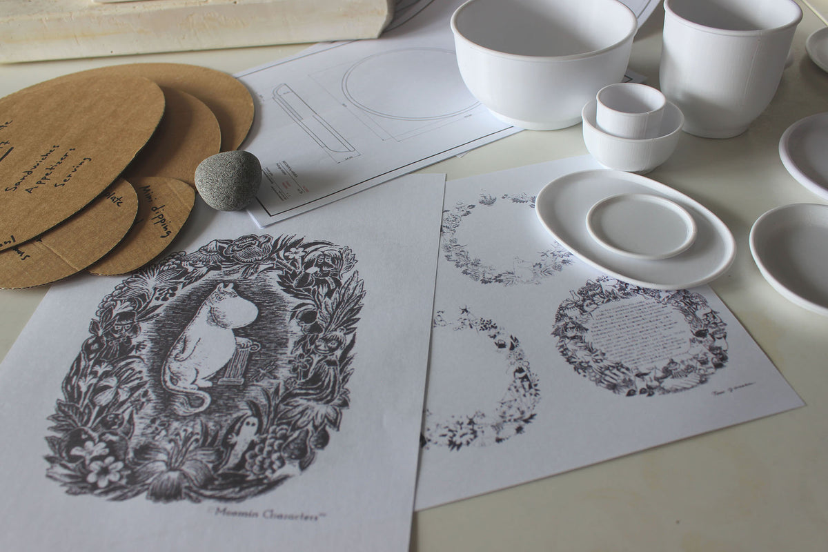 White ceramic plates and bowls on a table with printed Haru designs and templates.