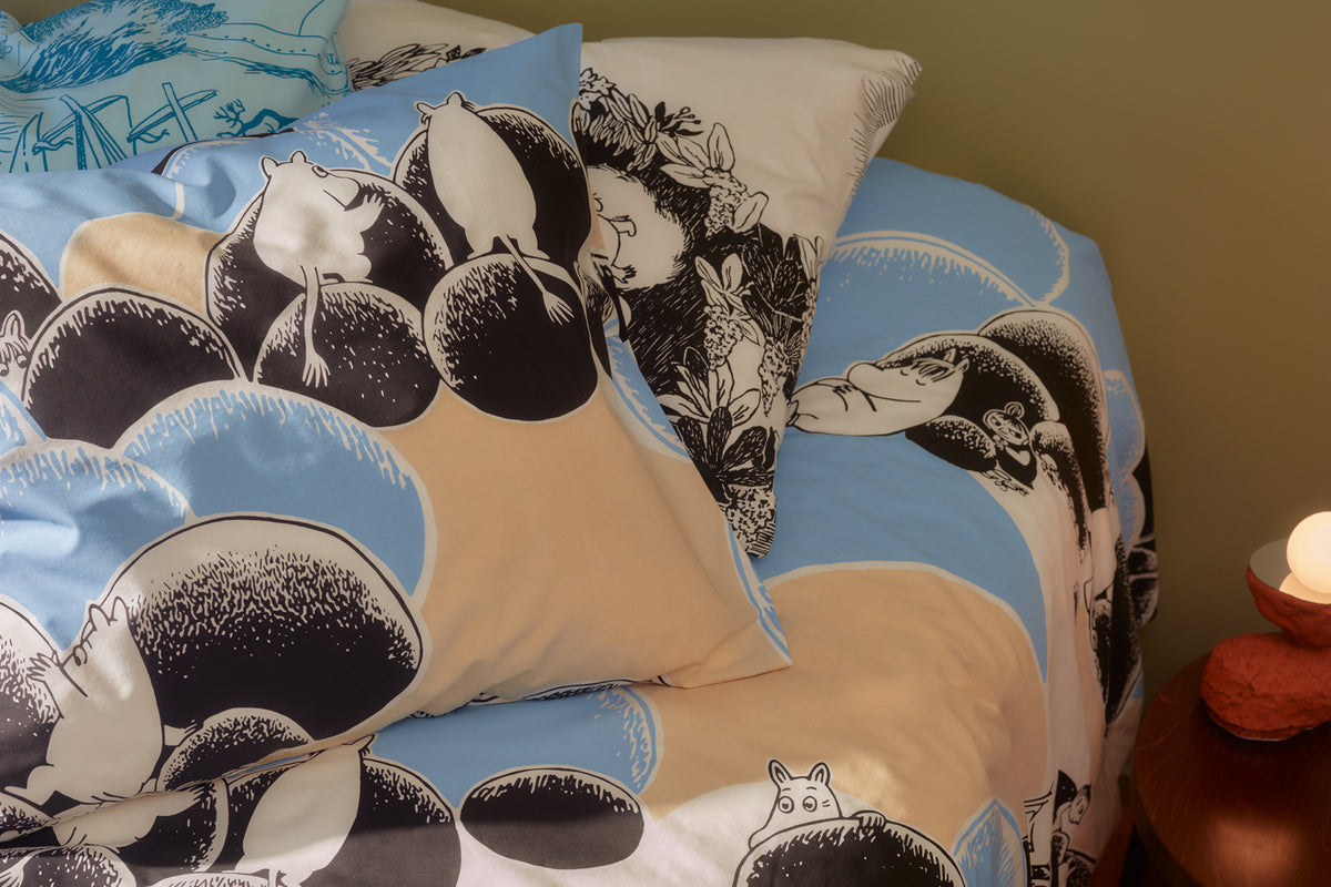 A bed made with the Pebbles bedding.