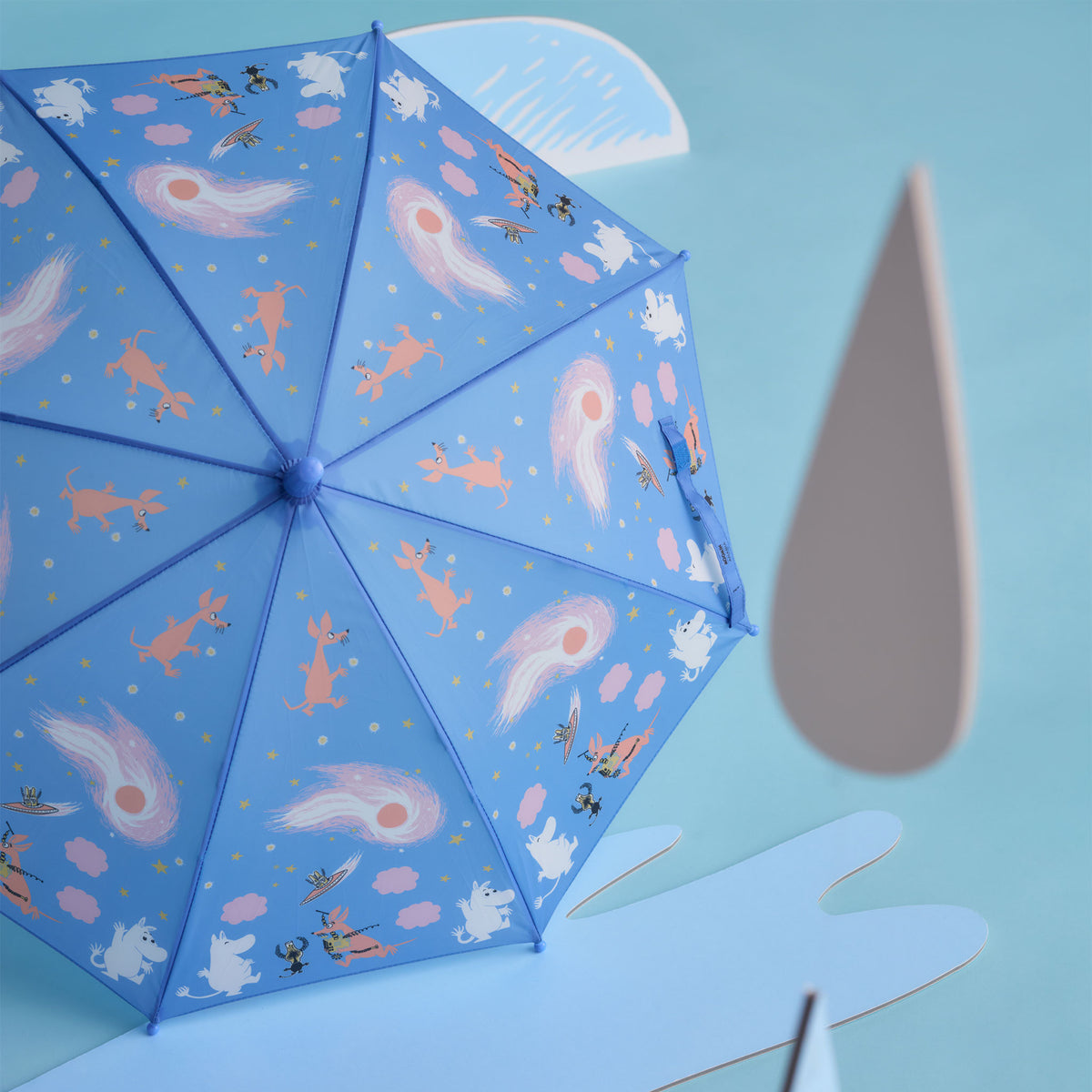 Moomin kids umbrella Space Adventure - A light blue umbrella with the Space Adventure illustration on a light blue background with paper cutout props.