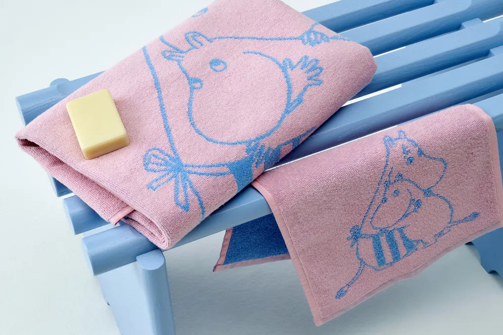 Pink towels with blue Moomin characters on a blue towel rack.