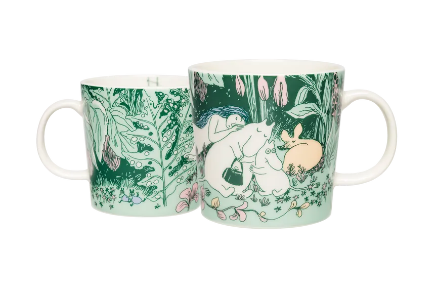 Two mugs with nature-themed designs featuring moomin characters sleeping on a forest floor